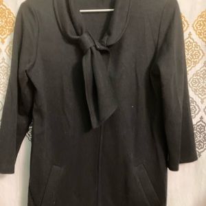 Black ¾ sleeve knit jacket with cool neck buttoning feature.